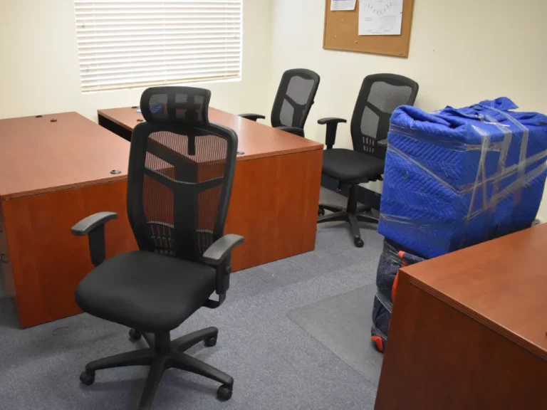 Office move, office chairs, packed cabinets and desks.