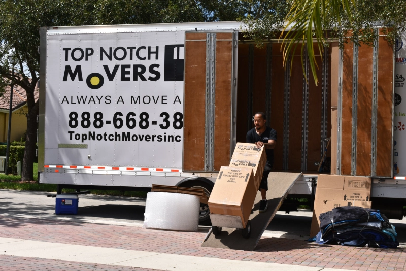 Local moving services in Boca Raton are done by our crew, here you can see one of our movers loading a truck with boxes