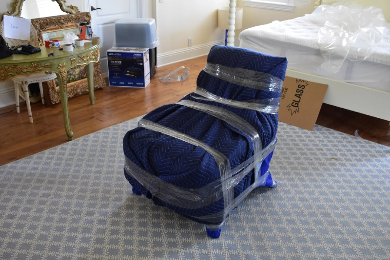 Large arm chair packed with moving blankets