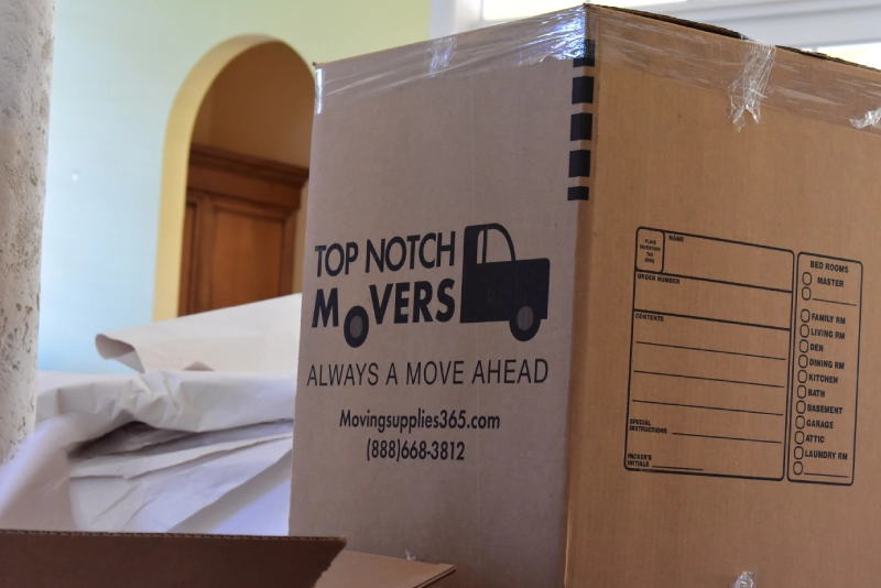 Large box for moving with Top Notch Movers signage on it