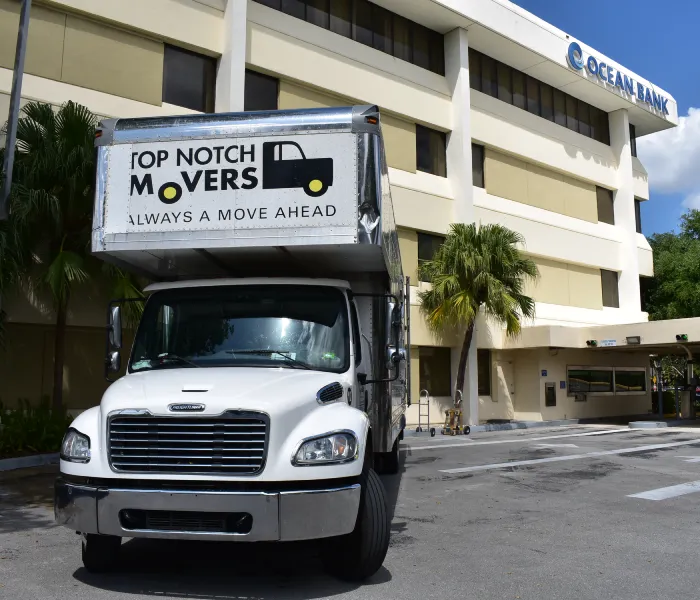 Top Notch Movers moving truck. Miami office moving. Truck is parked in front of the building.